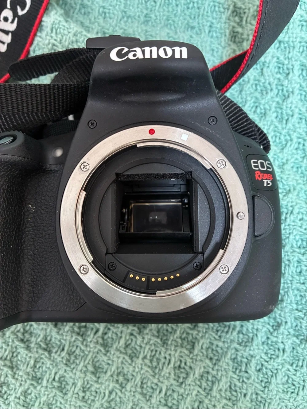 Canon DSLR Camera Body in Black with Red Strap Accents and kit lens.